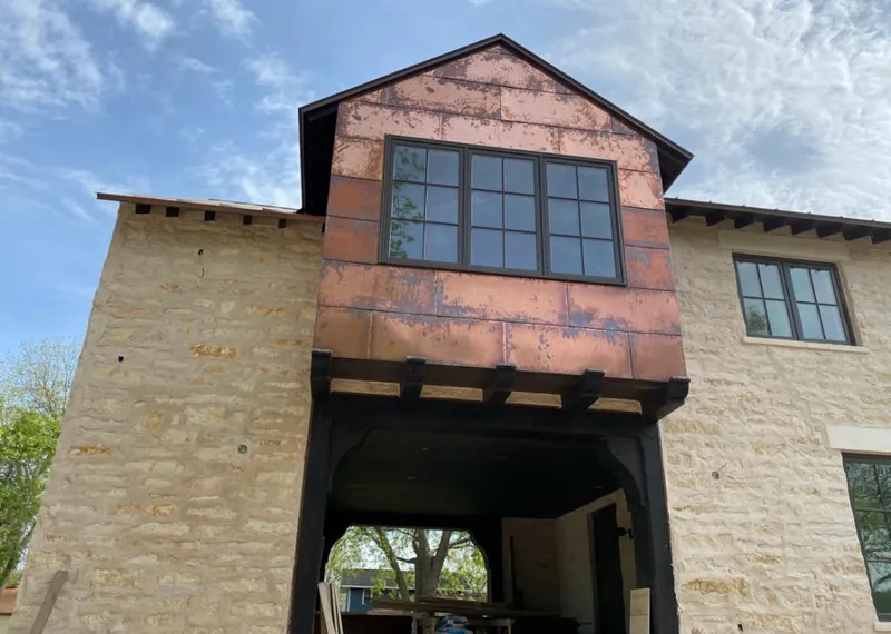 Copper metal panel facade on a stone building for Metal Roof Coating in Uvalde