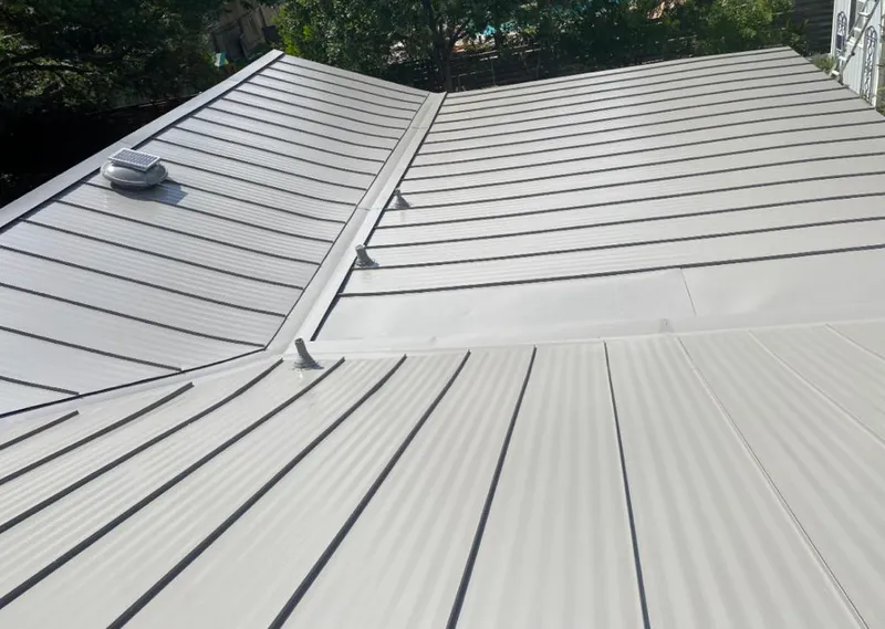 Solar attic fan installed on a metal roof for Roof Ventilation in Uvalde