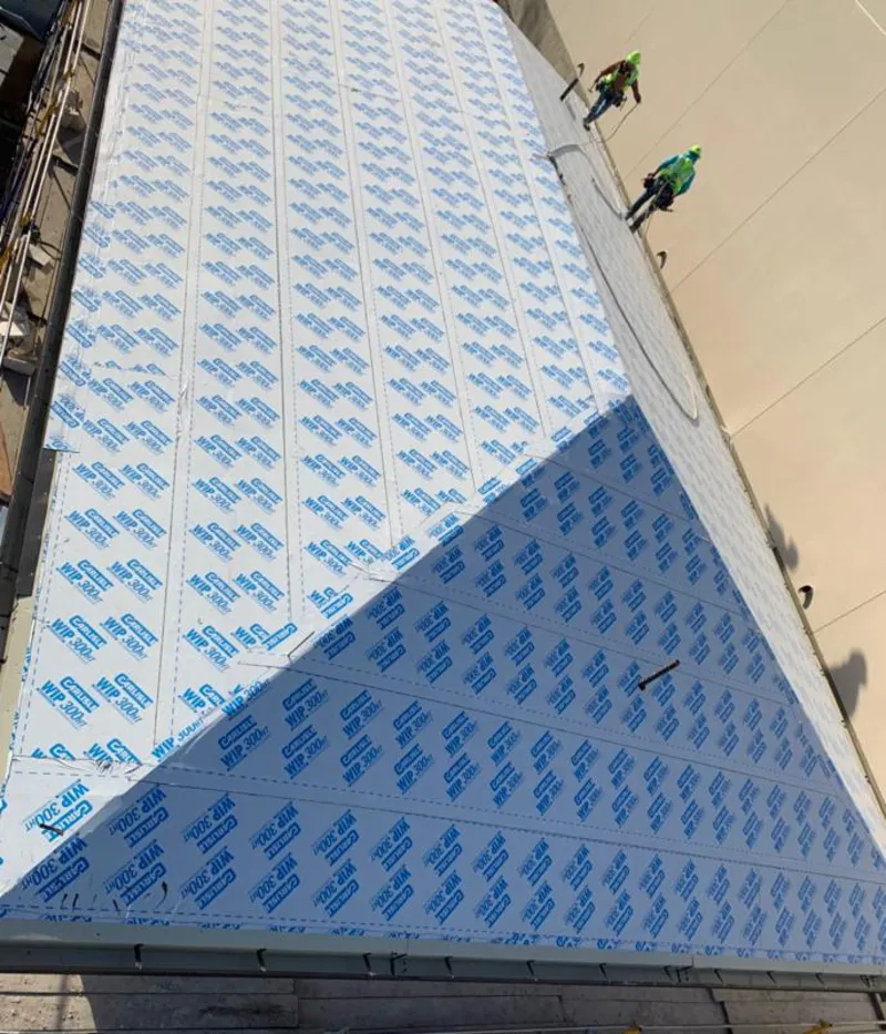 Professional roofers installing underlayment on a metal roof in Uvalde